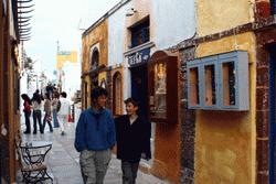 Therese and Paul walk the cobblestone streets of Oia